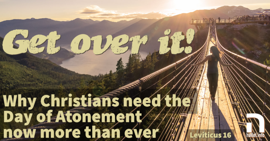 Get over it!: Why Christians need the Day of Atonement now more than ever (Leviticus 16). A woman walks across a cable foot bridge while looking at a lake at sunset.